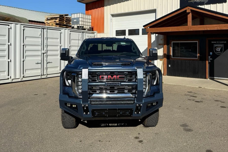 Blue-grey GMC Sierra HD with a Gridiron Full Tube front bumper